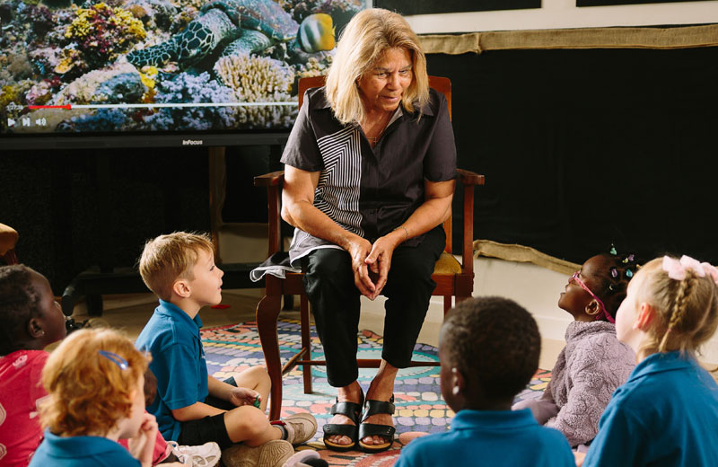 An educator leading a yarning circle with preschool children