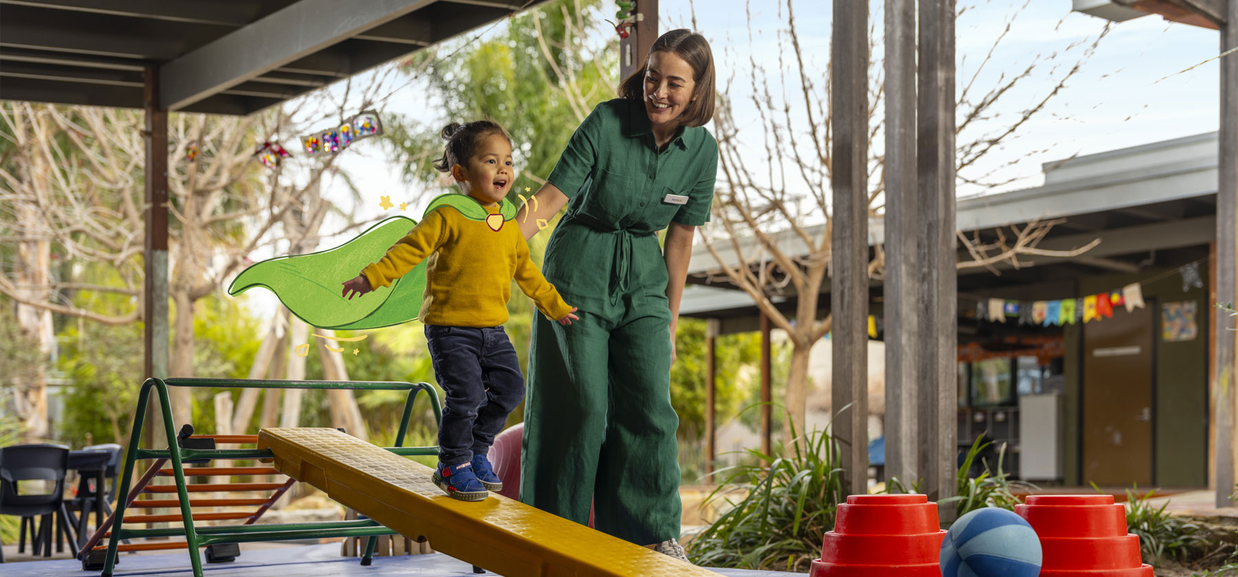 Child balancing on a beam guided by an adult in an early learning setting.