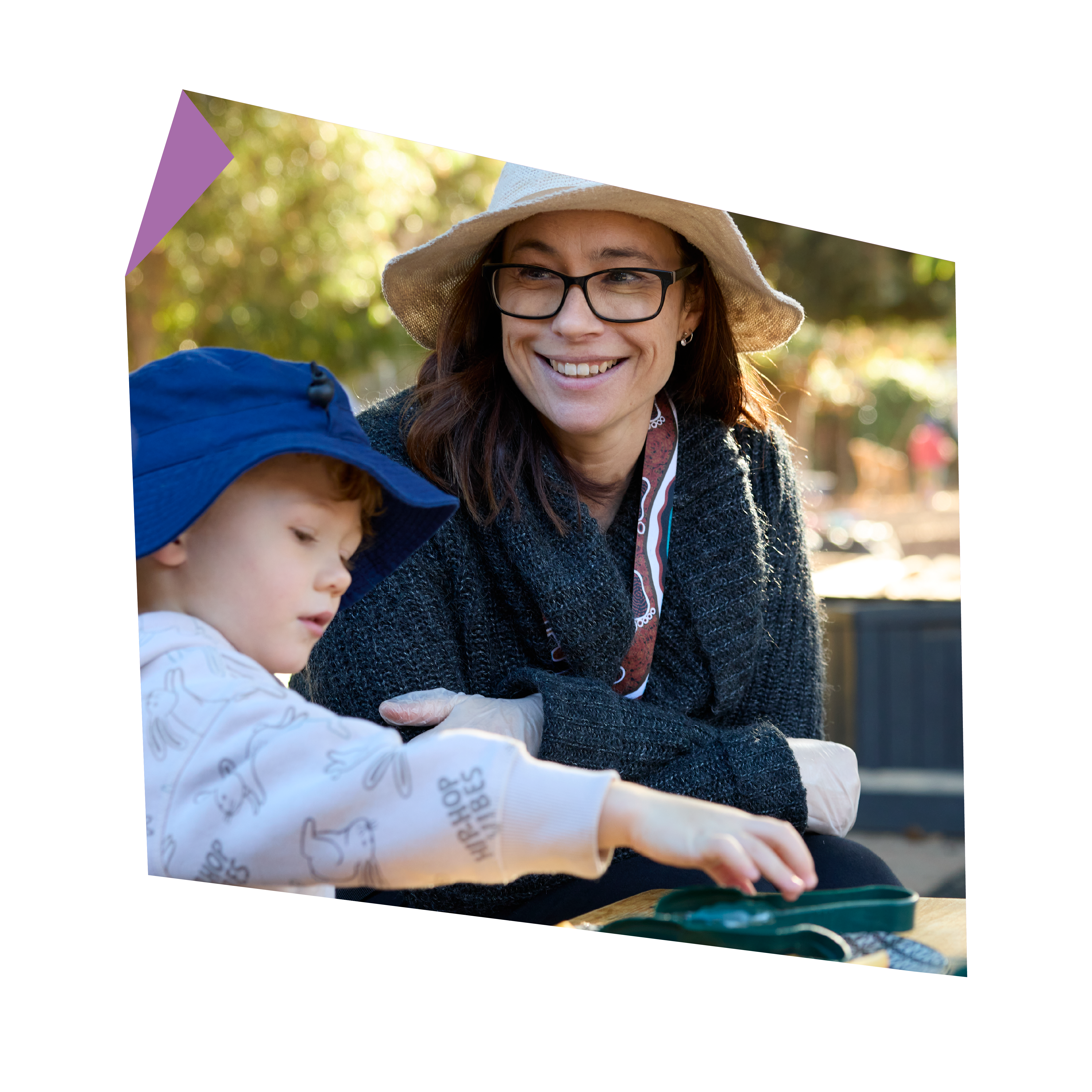 An educator smiling while playing with a child